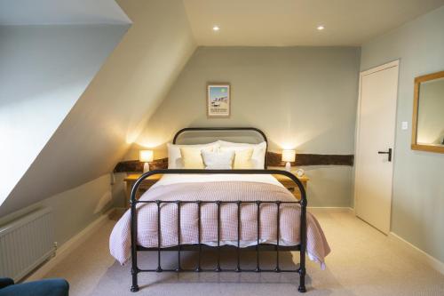 a small bedroom with a bed in the attic at The Cross Keys, Aldeburgh in Aldeburgh