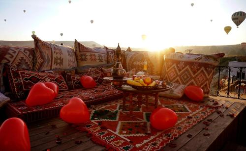 a living room with red heart chairs and a couch at Milat Cave Hotel in Goreme