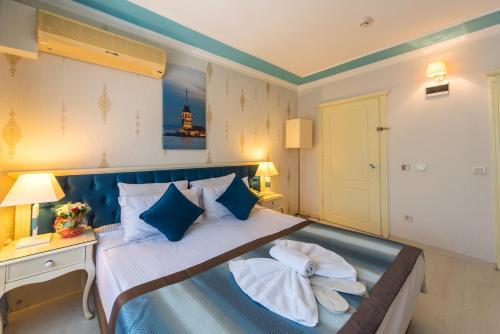 a bedroom with a bed with two towels on it at Viva Deluxe Hotel in Istanbul
