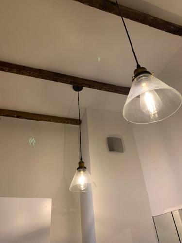 two lights hanging from the ceiling in a room at Royal Mile Suites by the Castle in Edinburgh