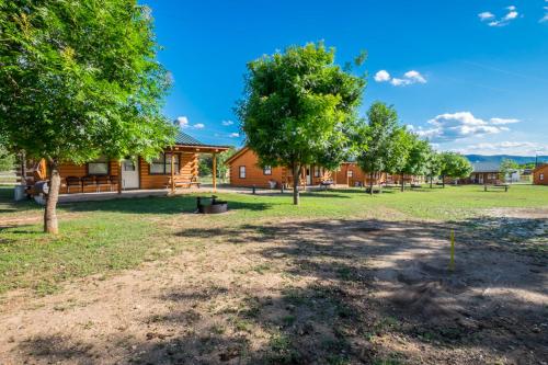 a group of trees in front of a house at River Bluff Cabins in Rio Frio