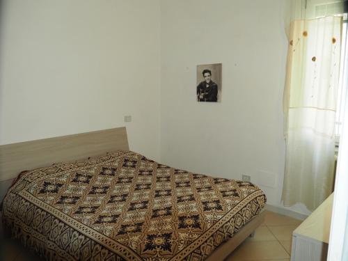 uma cama num quarto com uma fotografia na parede em Appartamento in Centro Storico, vicino alla Stazione e al Mare em Rimini