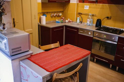 a kitchen with a microwave and a counter with a table at Historical center in Uzhhorod