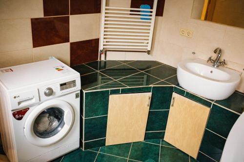 a bathroom with a washing machine and a sink at Historical center in Uzhhorod