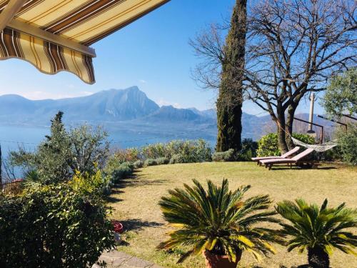 a patio with a bench and a view of the mountains at Casa Vacanze Mazurine10 in Torri del Benaco