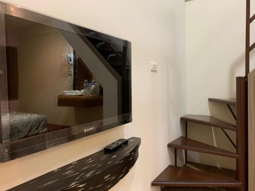a large flat screen tv hanging on a wall at Jia's Homestay in Lugu