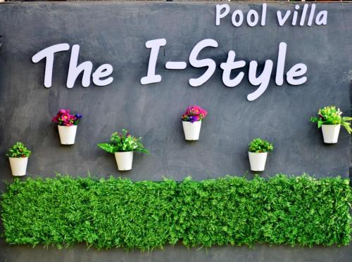 a sign that reads pool villa the i style with potted plants at The I-style pool villa in Ban Tao Than