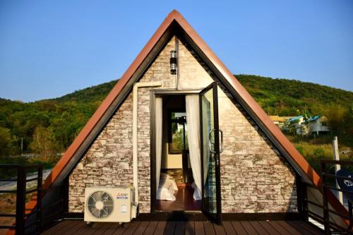 a small house with a thatched roof at The I-style pool villa in Ban Tao Than