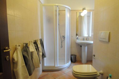 a bathroom with a shower and a toilet and a sink at Casa San Giorgio Varenna in Varenna