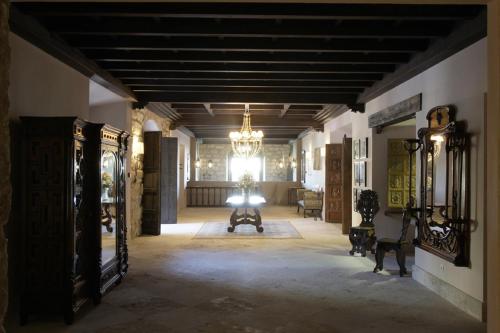 a large hallway with a chandelier and a room with at Hotel Palacio de Mengibar in Mengibar