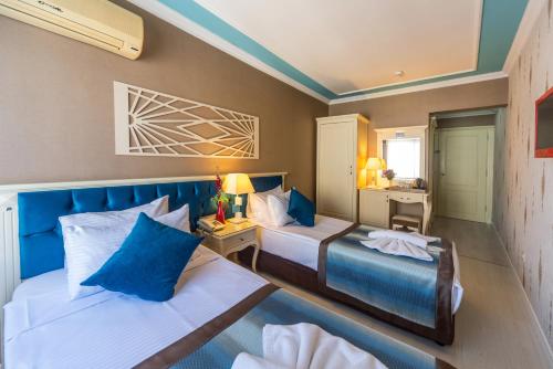 two beds in a room with blue and white at Viva Deluxe Hotel in Istanbul
