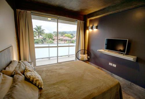 a bedroom with a bed and a large window at Depto 25 las Marías in San Salvador de Jujuy