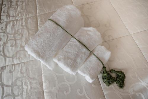 a pair of towels sitting on top of a bed at A due passi olbia in Olbia