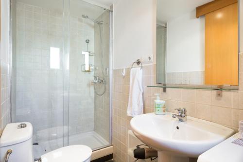 a bathroom with a sink and a toilet and a shower at Luxury Apartment Barcelona in Barcelona