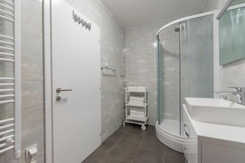 a bathroom with a shower and a sink and a tub at Villa Anja 2nd floor in Peroj