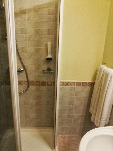 a bathroom with a shower and a toilet at Hotel Belvedere in Predeal