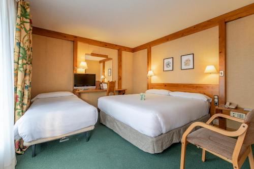 Säng eller sängar i ett rum på Sport Hotel