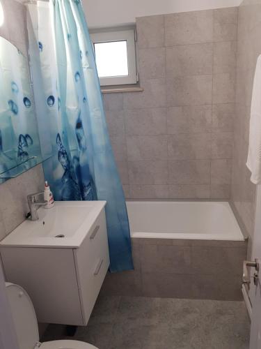 a bathroom with a bath tub and a shower curtain at Apartament Flo in Constanţa
