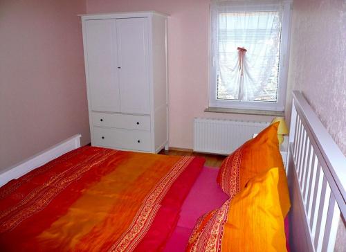 a small bedroom with a bed and a window at Ferienwohnung Fam. Gansau - Insel Usedom in Zirchow