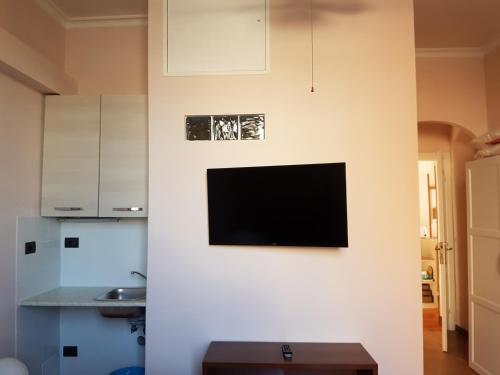 a living room with a tv on a wall at Chiara Rooms in Rome