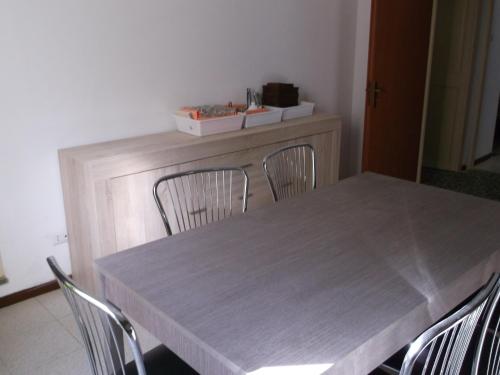 a table and chairs in a room with a table and a counter at centrostoricolipari in Lipari