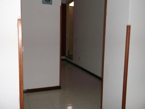 an empty hallway with a door and a tile floor at centrostoricolipari in Lipari