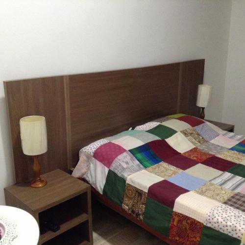 a bedroom with a bed with a colorful quilt at Finca El Sueño De Mi Abuelo in Pereira