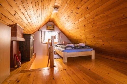 a bedroom with a bed in a wooden ceiling at House Franja - Spa and relax in Kranjska Gora