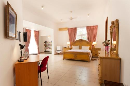 a hotel room with a bed and a desk and a desk at Villa 53 in Battaramulla