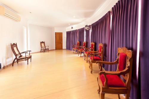 a waiting room with red chairs and purple curtains at Villa 53 in Battaramulla