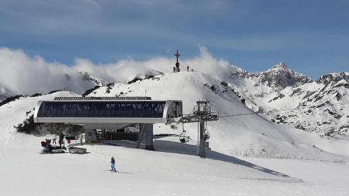 a ski lift on top of a snow covered mountain at Snežak (Snowman) 2 in Bohinj