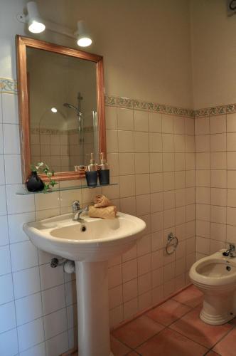 a bathroom with a sink and a toilet at 2BDR Townhouse Duplex with Pool by LovelyStay in Ferragudo