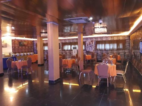 a dining room with tables and chairs in a building at Presken Hotels @ Abuja in Abuja