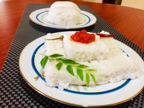 two slices of cake on a plate on a table at Sweet Home Tourist Rest, Cooking Classes & Tours in Anuradhapura