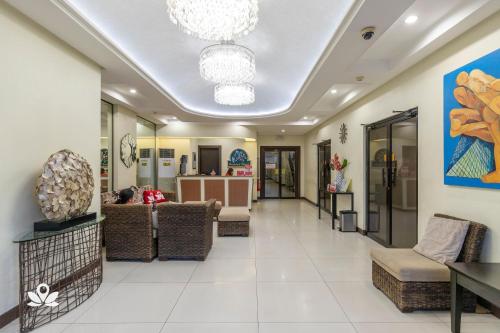 a lobby of a store with couches and chairs at Orchard Hotel Davao in Davao City