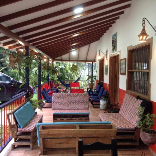 a patio with chairs and tables on a deck at Finca El Sueño De Mi Abuelo in Pereira