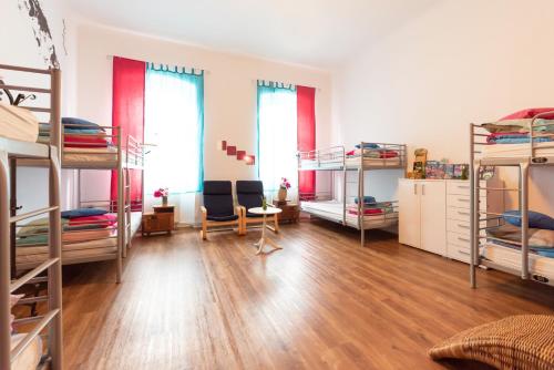 a room with a bunch of bunk beds at Fluxus Hostel in Ljubljana