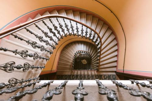 a spiral staircase in a building at Fluxus Hostel in Ljubljana