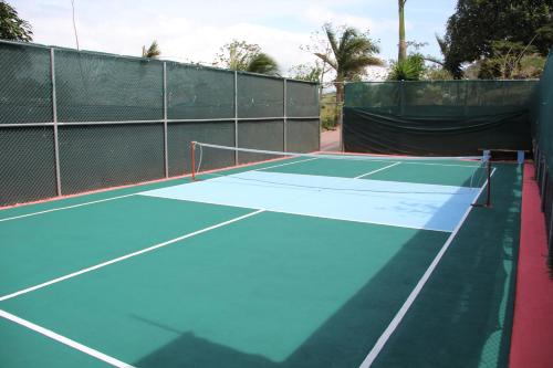 a tennis court with a net on top of it at Lake Arenal Condos in Naranjos Agrios