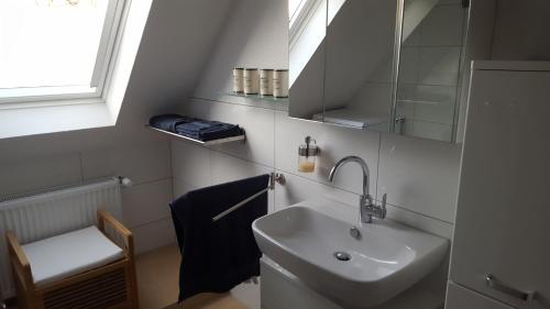 a bathroom with a sink and a mirror at Zimmervermietung Seefeld in Lingen