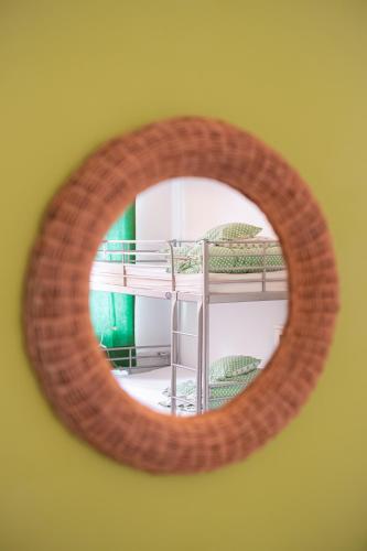 a mirror reflecting a room with a bunk bed at Fluxus Hostel in Ljubljana