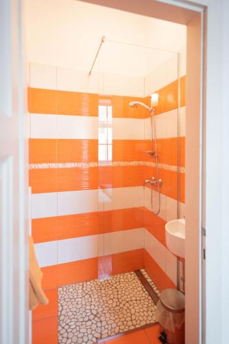 a bathroom with a shower and a sink at Fluxus Hostel in Ljubljana
