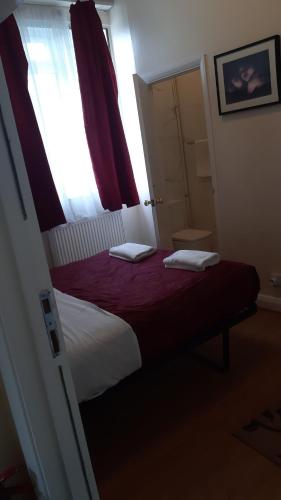 Ένα ή περισσότερα κρεβάτια σε δωμάτιο στο Chiswick Lodge Hotel