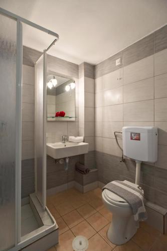 a bathroom with a toilet and a sink at KORMORANOS BEACH in Acharavi
