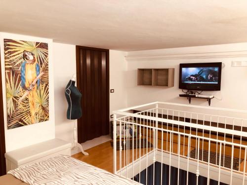 a bedroom with a crib and a tv on a wall at La Dimora del Viaggiatore Luxury Apartments in Mazara del Vallo