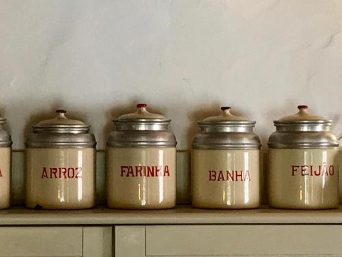 a group of five jars sitting on a shelf at Casa Pedralva in Vila do Bispo