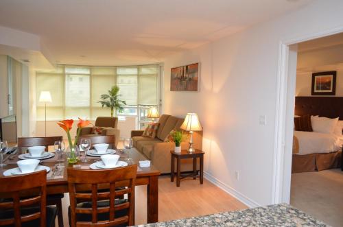 a living room with a dining table and a living room at Bombay Suites Mississauga in Mississauga