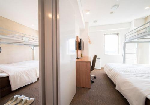 een hotelkamer met 2 bedden en een televisie bij Iwaki - Hotel / Vacation STAY 22988 in Iwaki