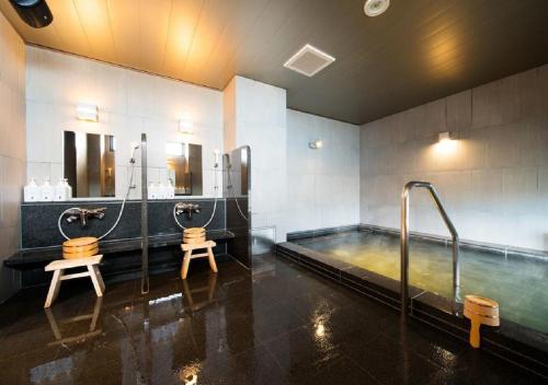 a bathroom with a hot tub and two toilets at Iwaki - Hotel / Vacation STAY 22823 in Iwaki