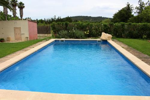 una gran piscina azul en un patio en Es garballons, en Manacor